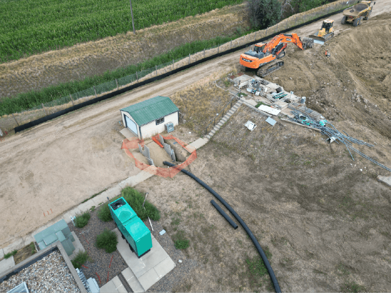 Aerial image of a construction site showcasing a bypass pipe leading to the onsite pump station.