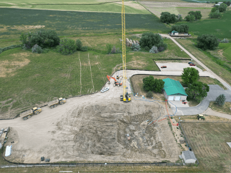 Aerial view of a construction site featuring a crane, showcasing the development of Niwot Sanitation's new Headworks building.