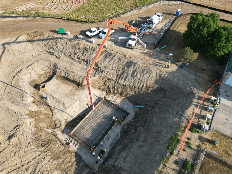 Aerial view of a construction site featuring a crane, showcasing the development of Niwot Sanitation's new Headworks building.