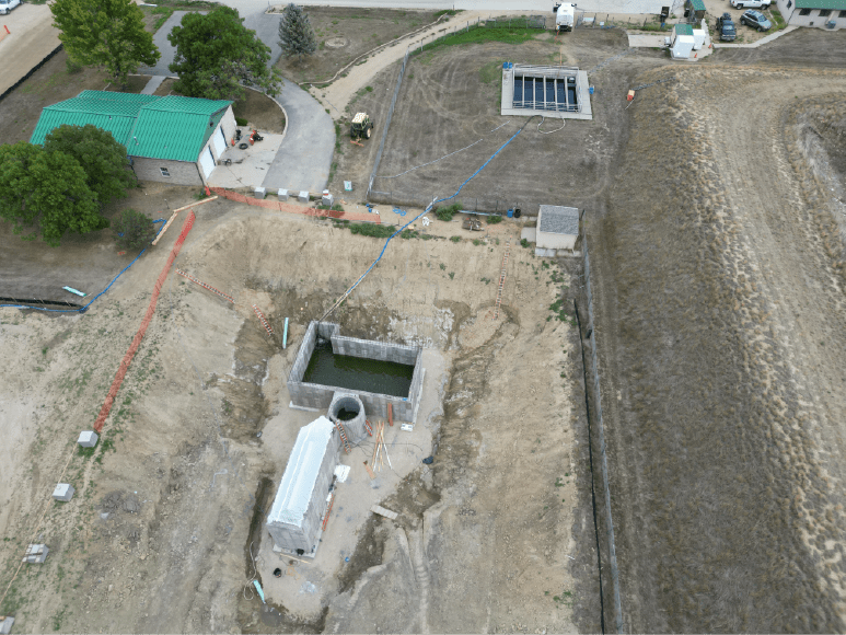 Aerial view of a construction site featuring a crane, showcasing the development of Niwot Sanitation's new Headworks building.