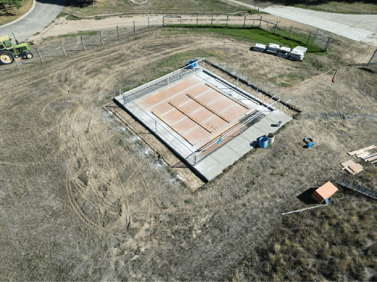 Aerial image of a construction site showcasing a fully covered chlorine contact chamber and the start of a UV building project.